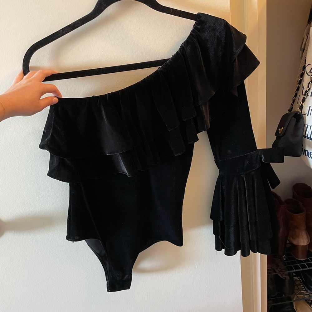 Velvet one shoulder bodysuit with snap closure.